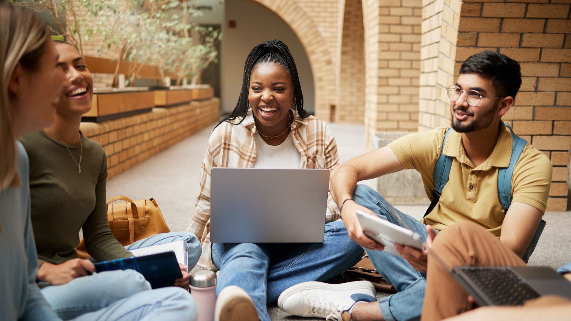 group of college students sitting outside