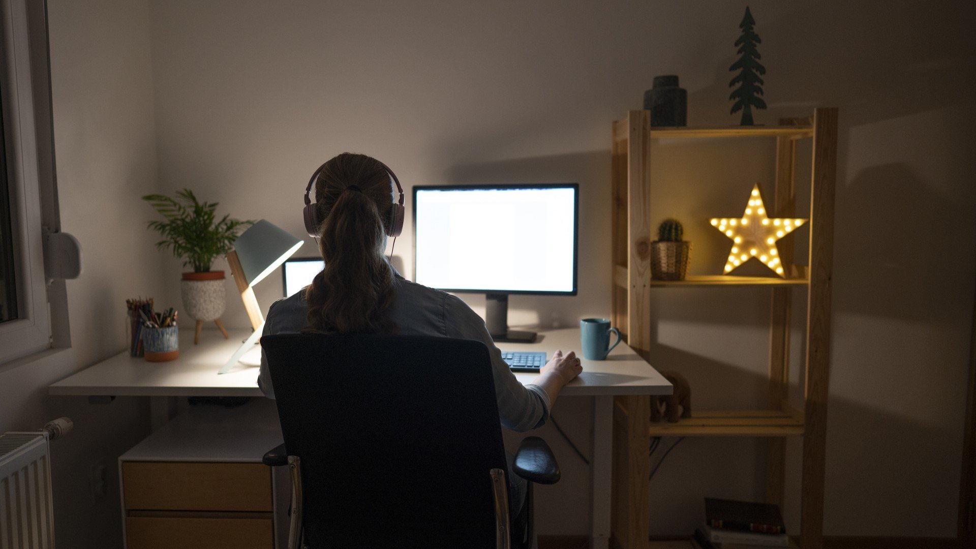 student with headphones on computer