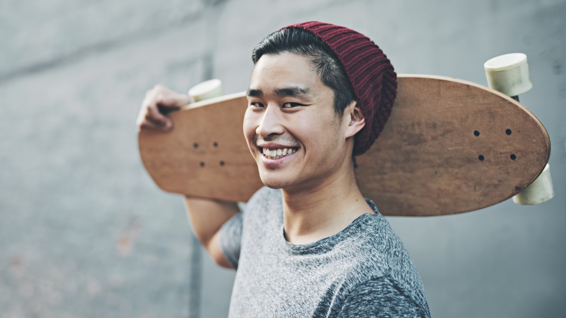 student holding skateboard