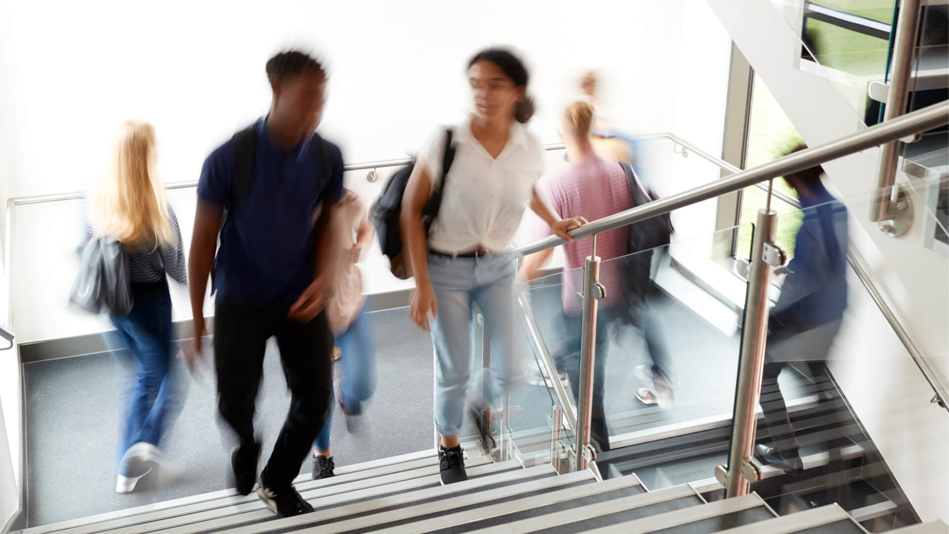 blurry shot of students walking up stairs