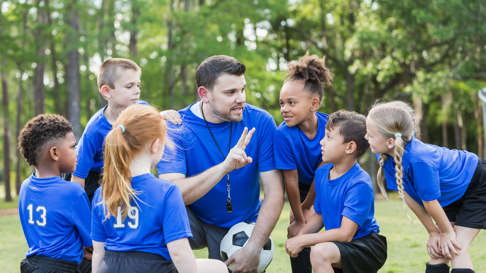 soccer coach with children