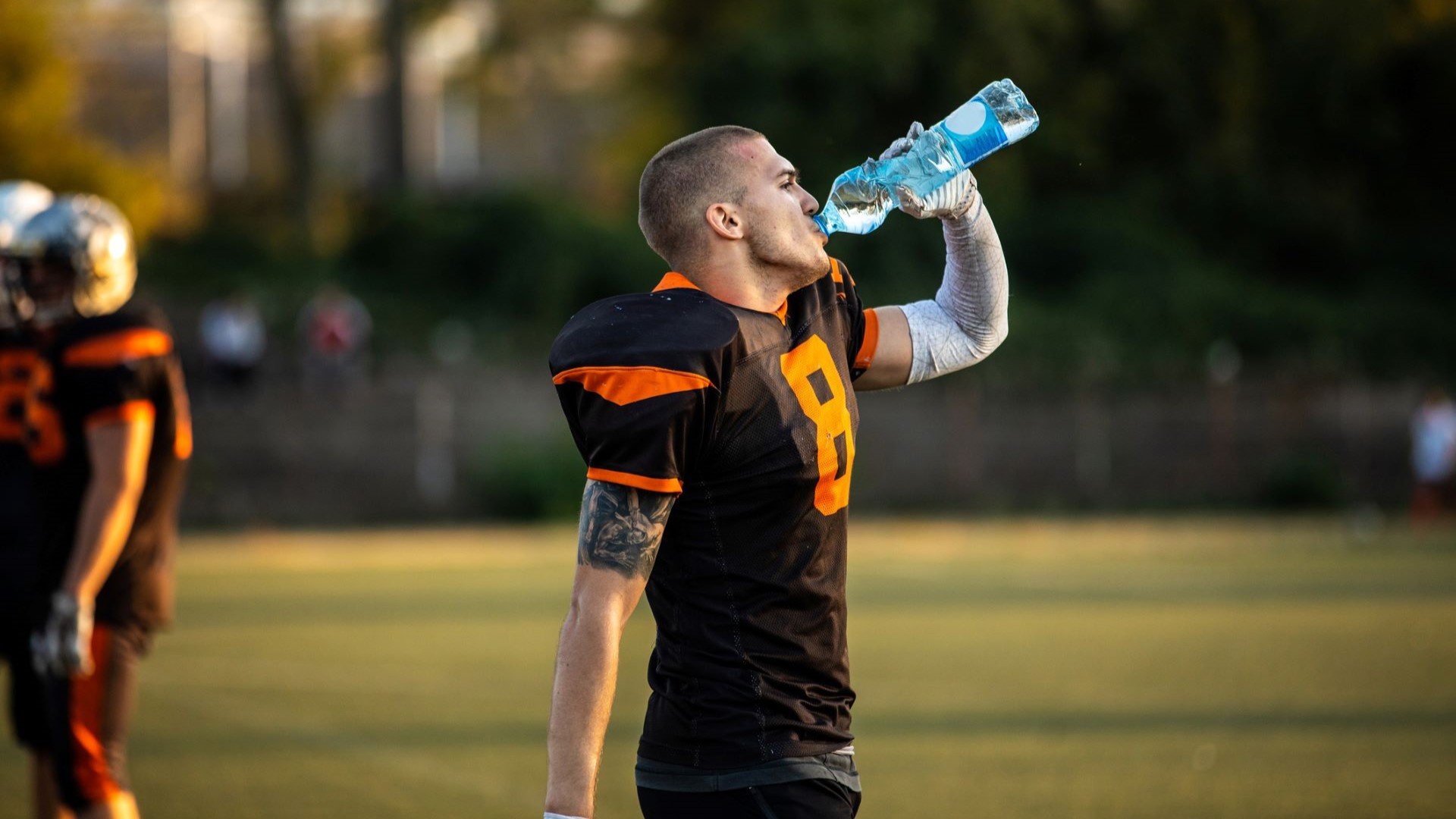 football player drinking water
