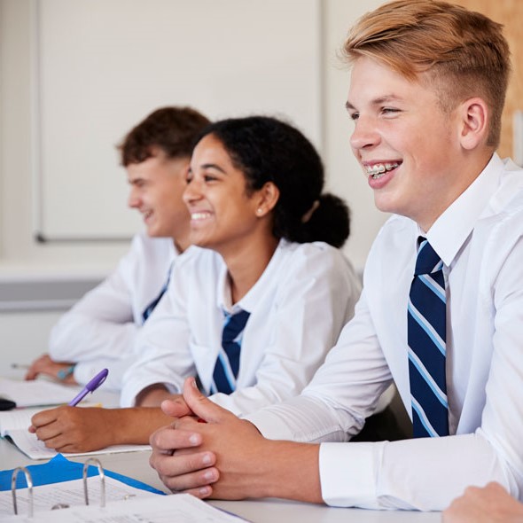 Private schools students sitting at desk