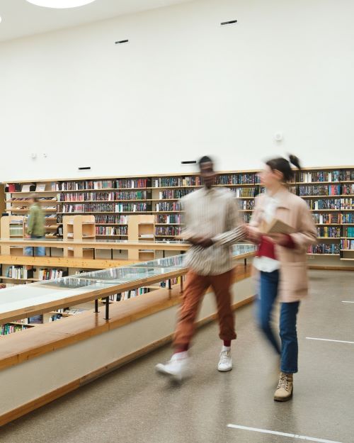 blurry image of students walking in library