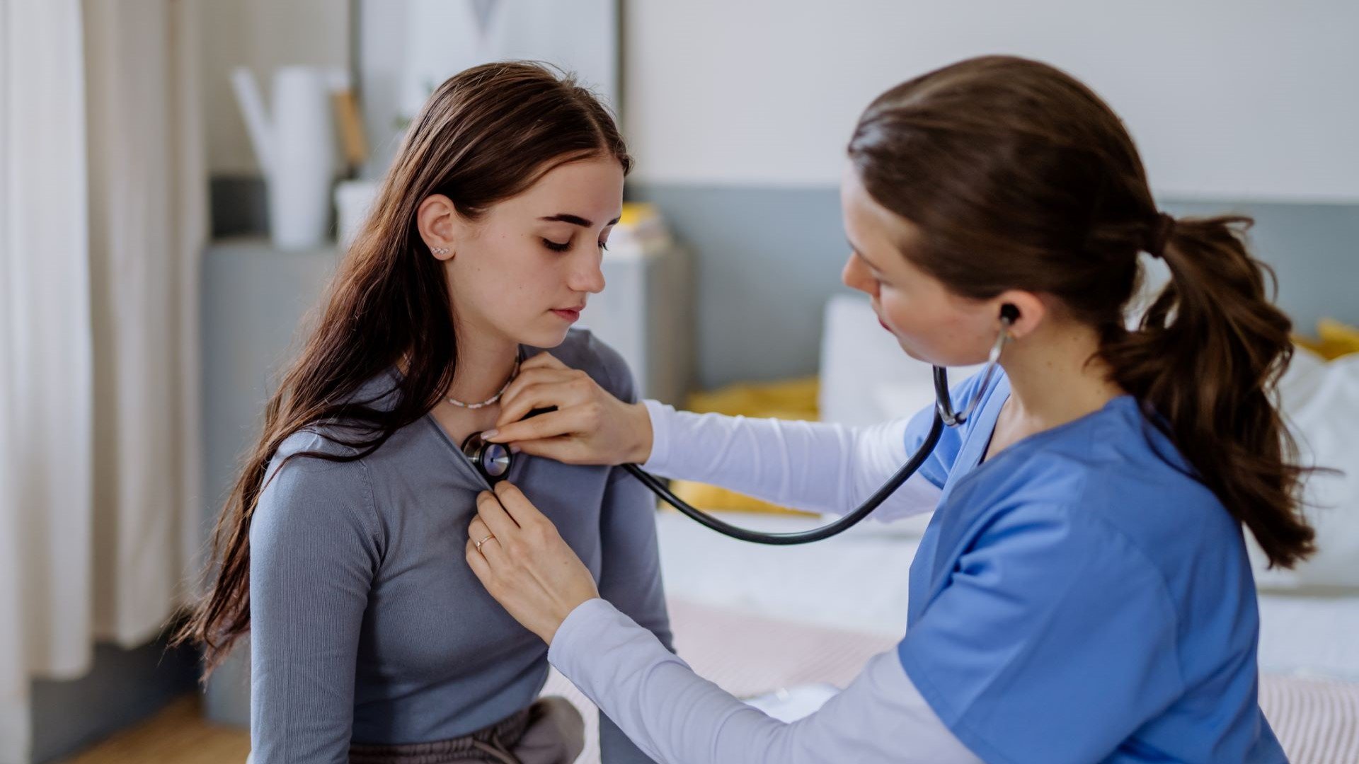 student recieving physical exam