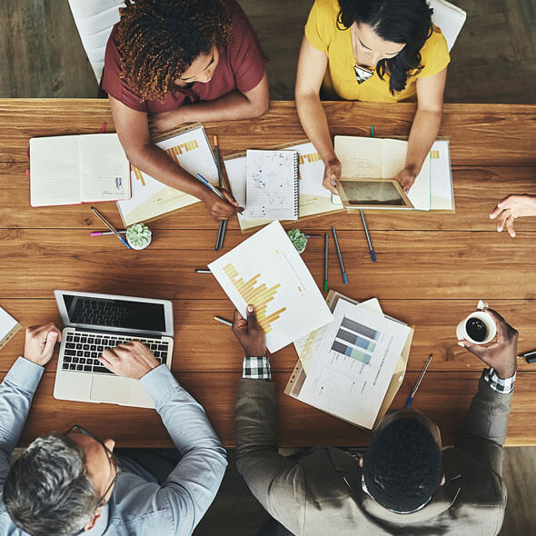aerial view of coworkers sitting at table