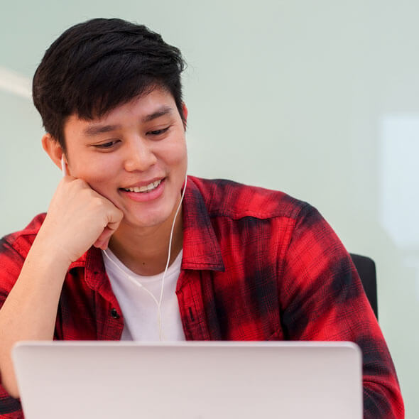 high school student working on laptop