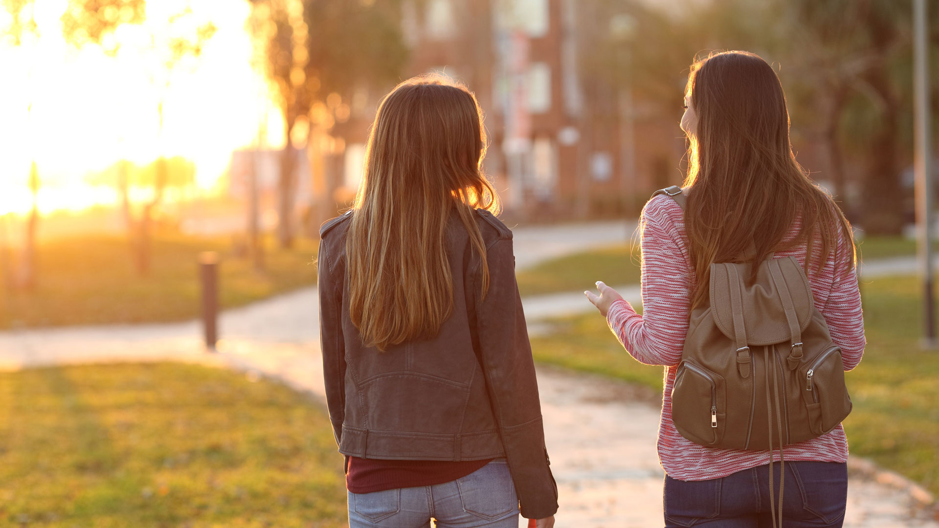 student and visitor walking across campus